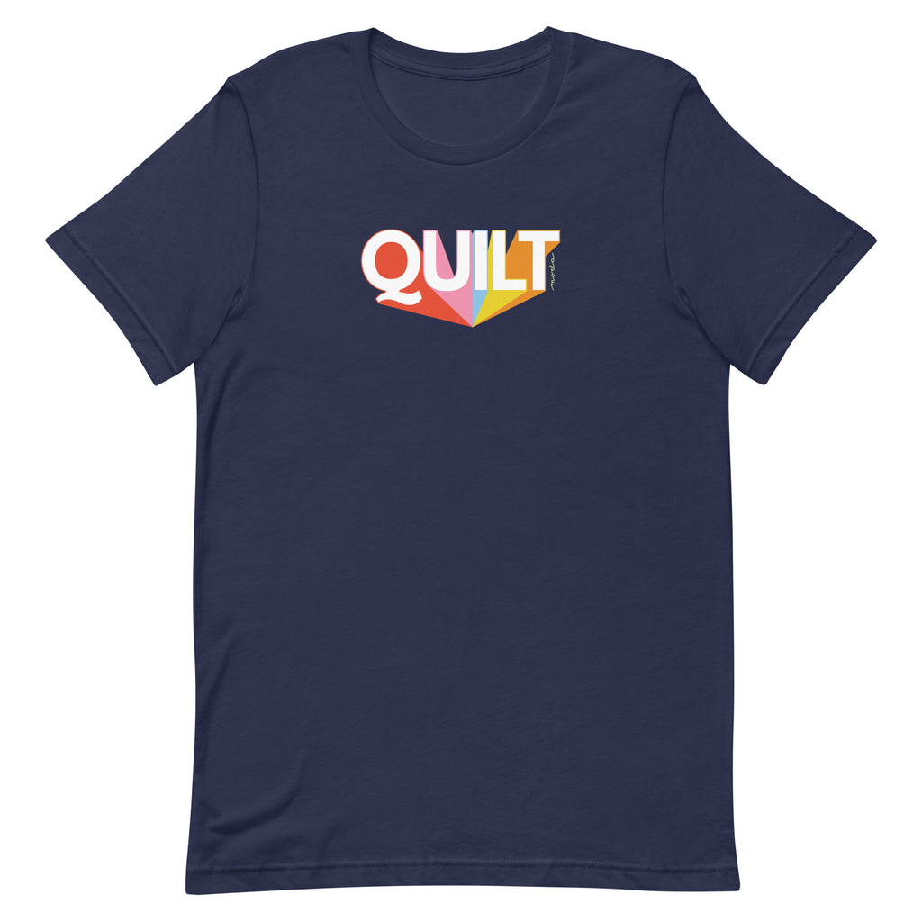 Moda QUILT logo with orange, pink, blue and yellow rays on a staple t-shirt in navy, front view – Kate Spain design