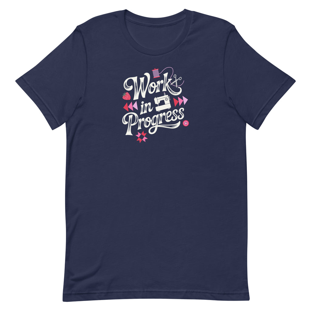 Work in Progress sewing design with flying geese, sewing machine, strawberry and thread spool on a t-shirt in navy, front view – Kate Spain design for Pat Sloan