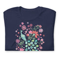 Peacock Flowers design, a peacock among coral, pink, mint and teal blooms on a t-shirt in navy, folded close-up of the design – Kate Spain design