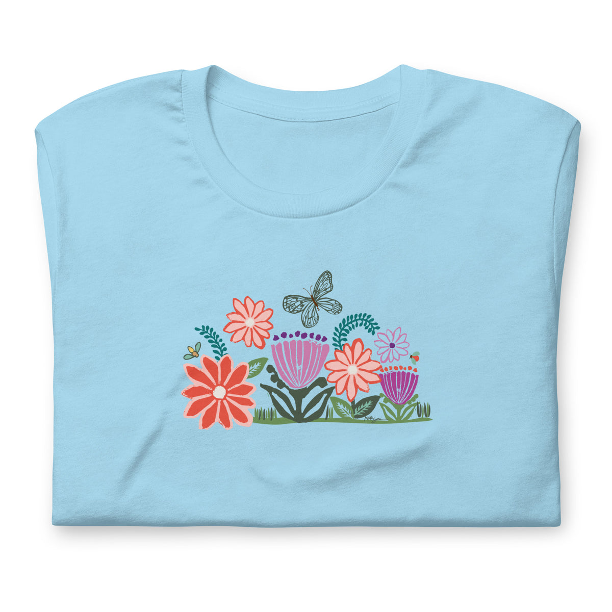 Bloom woodblock-style flowers with a butterfly, ladybug and bee on a t-shirt in ocean blue, folded close-up of the design – Kate Spain design