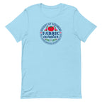 Fabric Curator Society of Stashers badge with a tomato pincushion on a t-shirt in ocean blue, front view – Kate Spain design for Pat Sloan