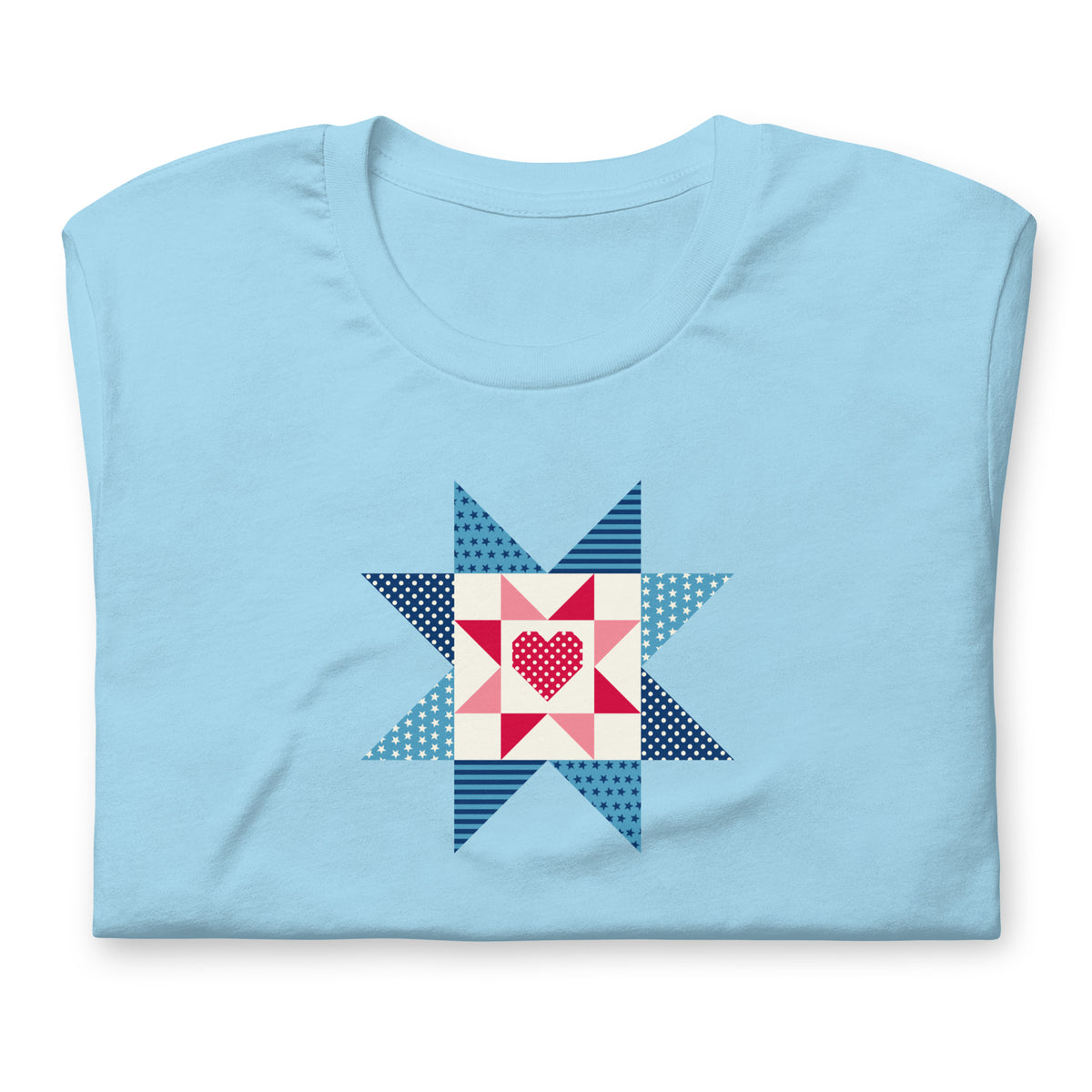 Liberty Love star quilt block with a heart in red, white and blue on a t-shirt in ocean blue, folded close-up of the design – Kate Spain design for Pat Sloan