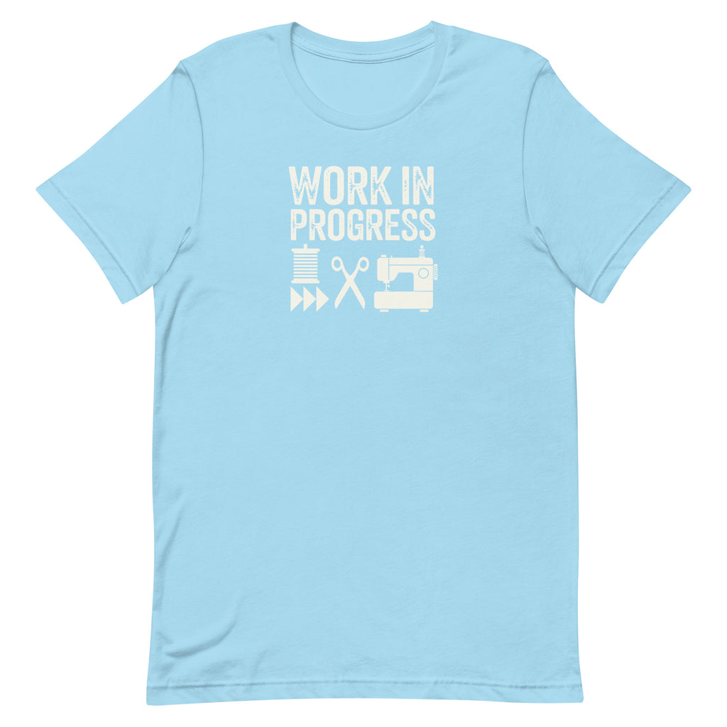 Work in Progress Mod distressed lettering with thread, scissors and sewing machine on a t-shirt in ocean blue, front view – Kate Spain design for Pat Sloan