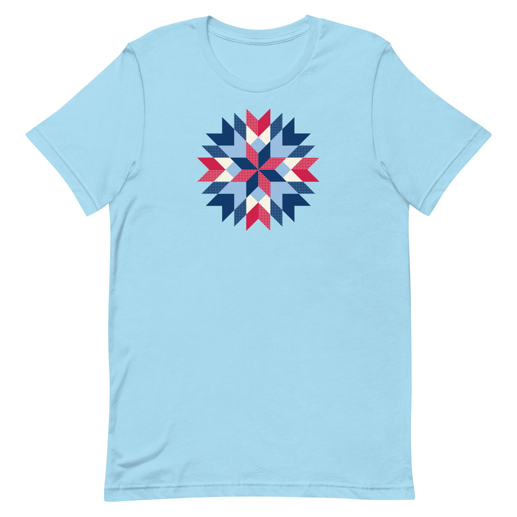 Barn Star quilt block in red, white and blue on a staple t-shirt in ocean blue, front view – Kate Spain design for Pat Sloan