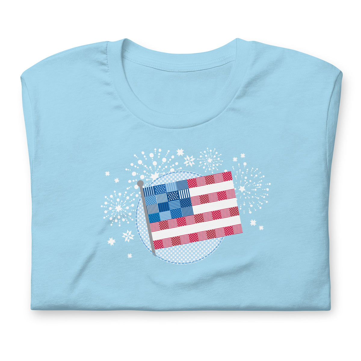 Patchwork Flag quilt-style flag with fireworks on a staple t-shirt in ocean blue, folded close-up of the design – Kate Spain design for Pat Sloan
