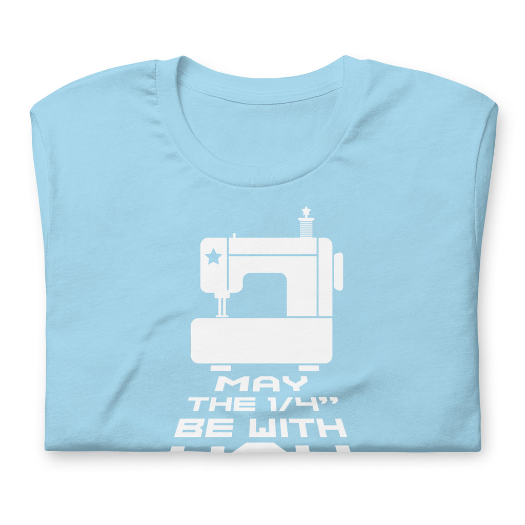 May the ¼" Be With You white sewing machine graphic on a staple t-shirt in ocean blue, folded close-up of the design – Kate Spain design for Pat Sloan