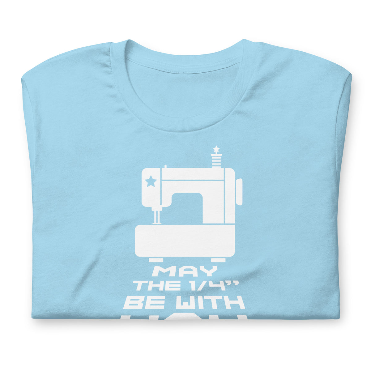 May the ¼" Be With You white sewing machine graphic on a staple t-shirt in ocean blue, folded close-up of the design – Kate Spain design for Pat Sloan