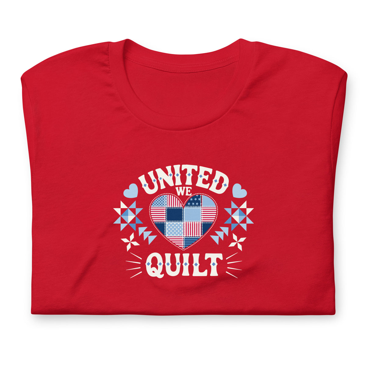 Quilters United quilt badge in red, white and blue on a t-shirt in red, folded close-up of the design – Kate Spain design for Pat Sloan