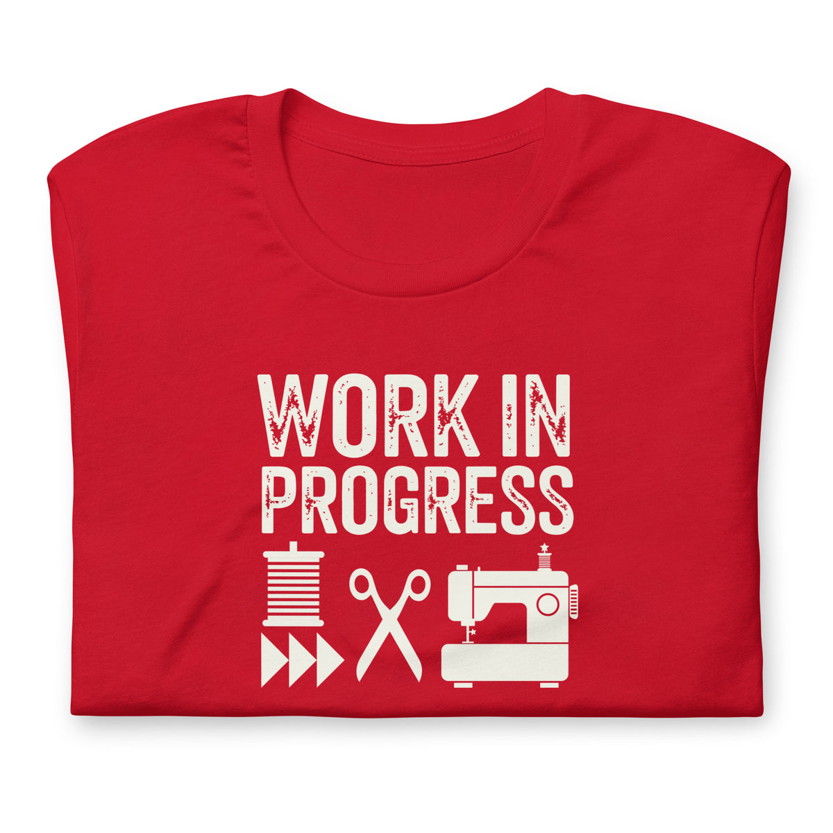 Work in Progress Mod distressed lettering with thread, scissors and sewing machine on a t-shirt in red, folded close-up of the design – Kate Spain design for Pat Sloan