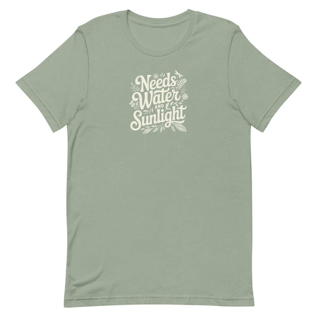Needs Water + Sunlight hand lettering with leaf and sun accents on a t-shirt in sage, front view – Kate Spain design