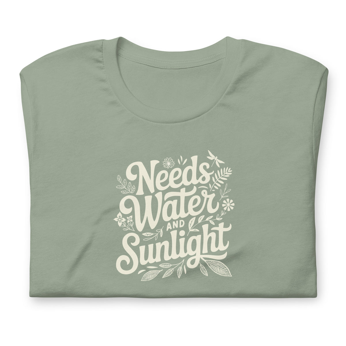 Needs Water + Sunlight hand lettering with leaf and sun accents on a t-shirt in sage, folded close-up of the design – Kate Spain design