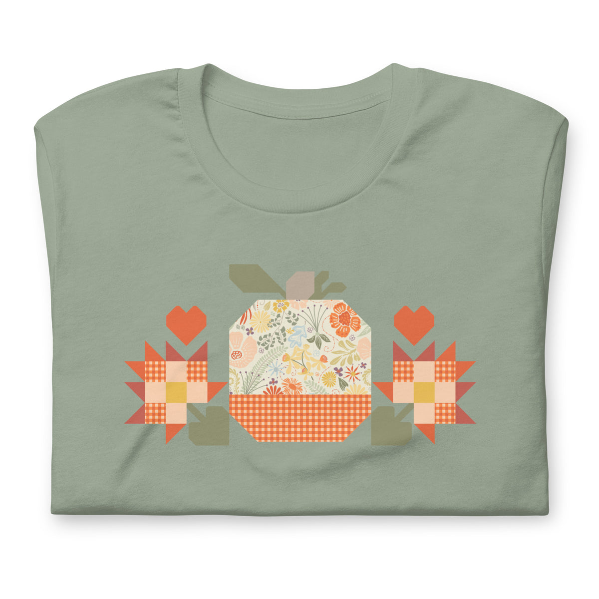 Falling for Fall patchwork pumpkin with quilt-block stars and hearts on a t-shirt in sage, folded close-up of the design – Kate Spain design for Pat Sloan