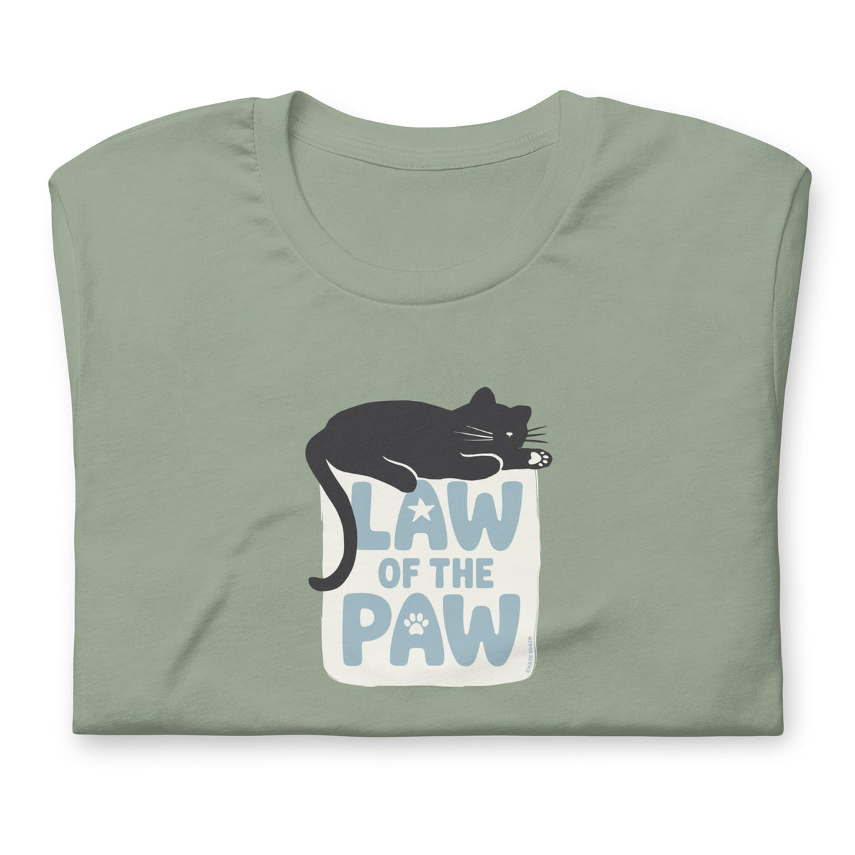 Law of the Paw® design with a cat napping on the logo on a t-shirt in sage, folded close-up of the design – Kate Spain design