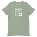 Work in Progress Mod distressed lettering with thread, scissors and sewing machine on a t-shirt in sage, front view – Kate Spain design for Pat Sloan