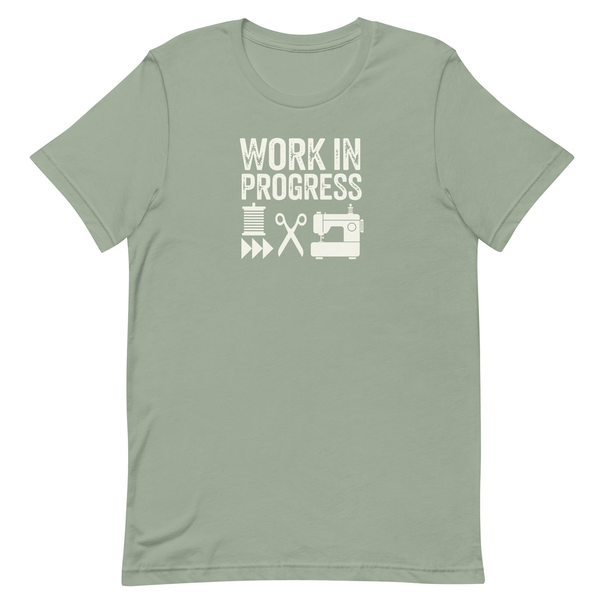 Work in Progress Mod distressed lettering with thread, scissors and sewing machine on a t-shirt in sage, front view – Kate Spain design for Pat Sloan