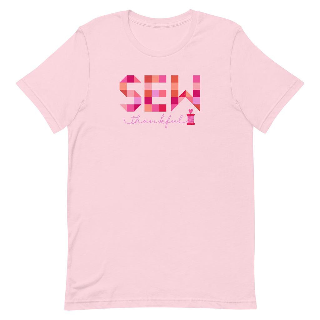 Sew Thankful patchwork lettering with a heart-topped thread spool on a t-shirt in pink, front view – Kate Spain design for Pat Sloan