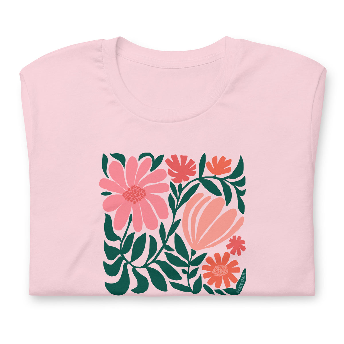Botanica modern floral design with pink and coral blooms on a t-shirt in pink, folded close-up of the design – Kate Spain design