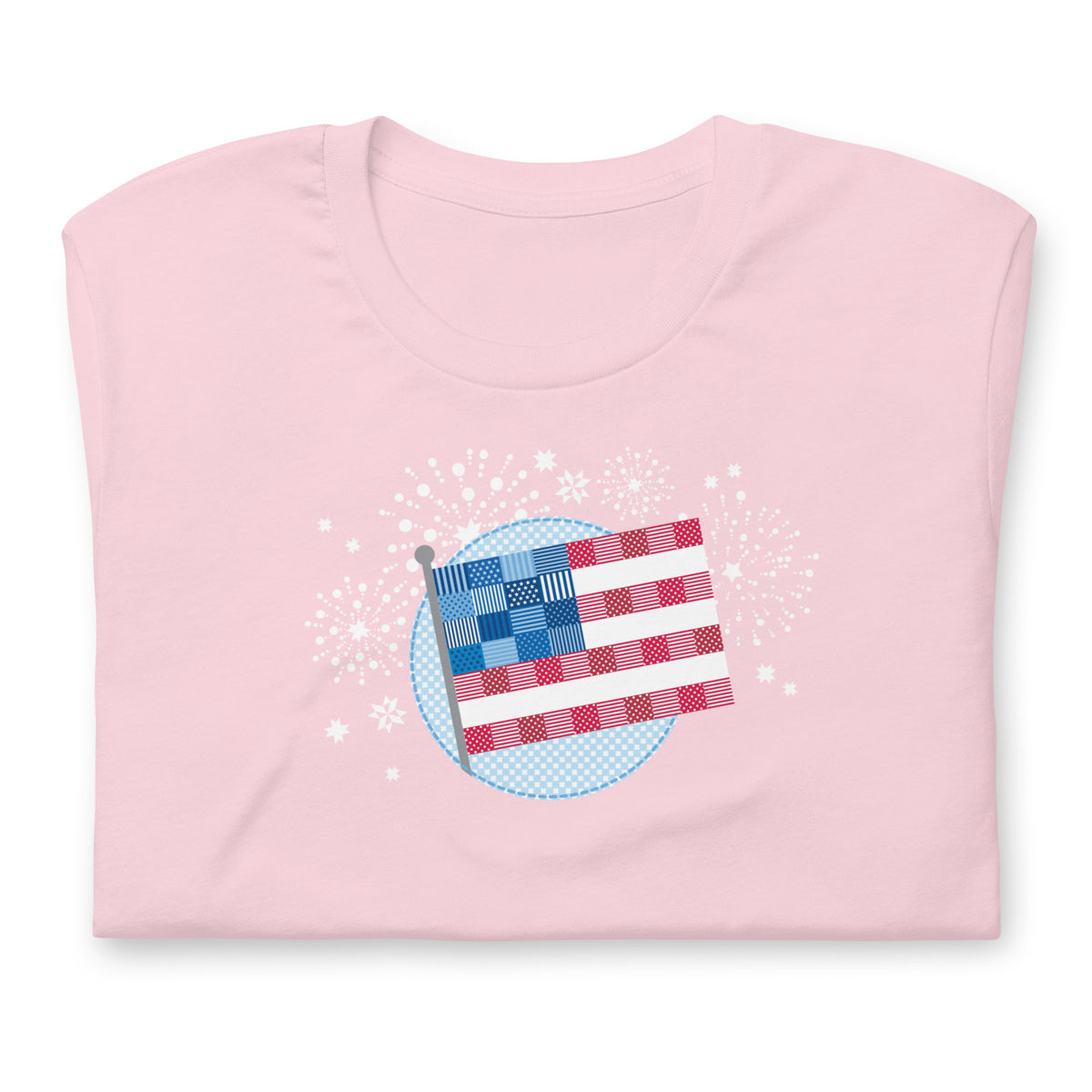 Patchwork Flag quilt-style flag with fireworks on a staple t-shirt in soft pink, folded close-up of the design – Kate Spain design for Pat Sloan
