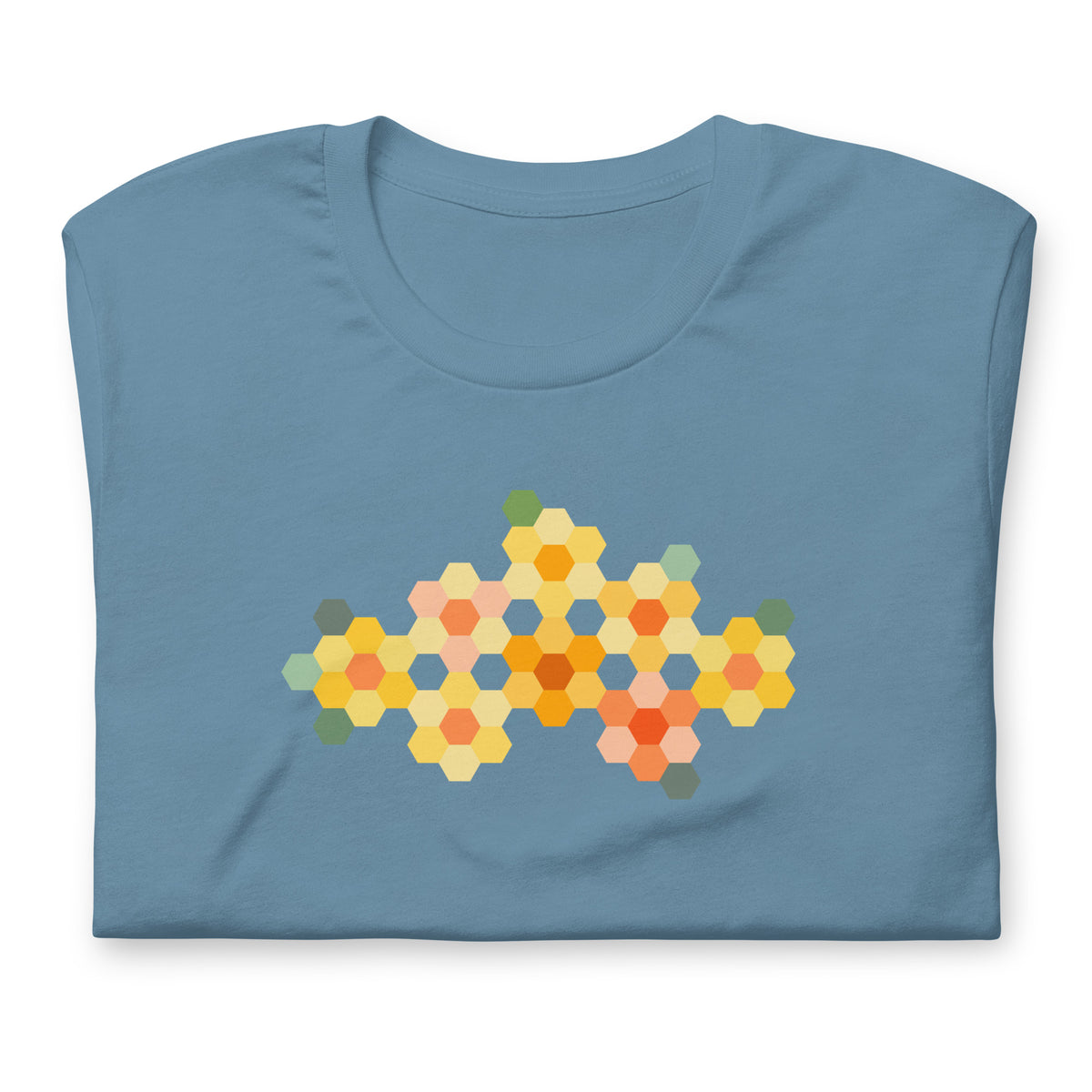 Yellow GeoFlora hexagon flowers in golden yellow, orange, coral and sage on a t-shirt in steel blue, folded close-up of the design – Kate Spain design for Pat Sloan