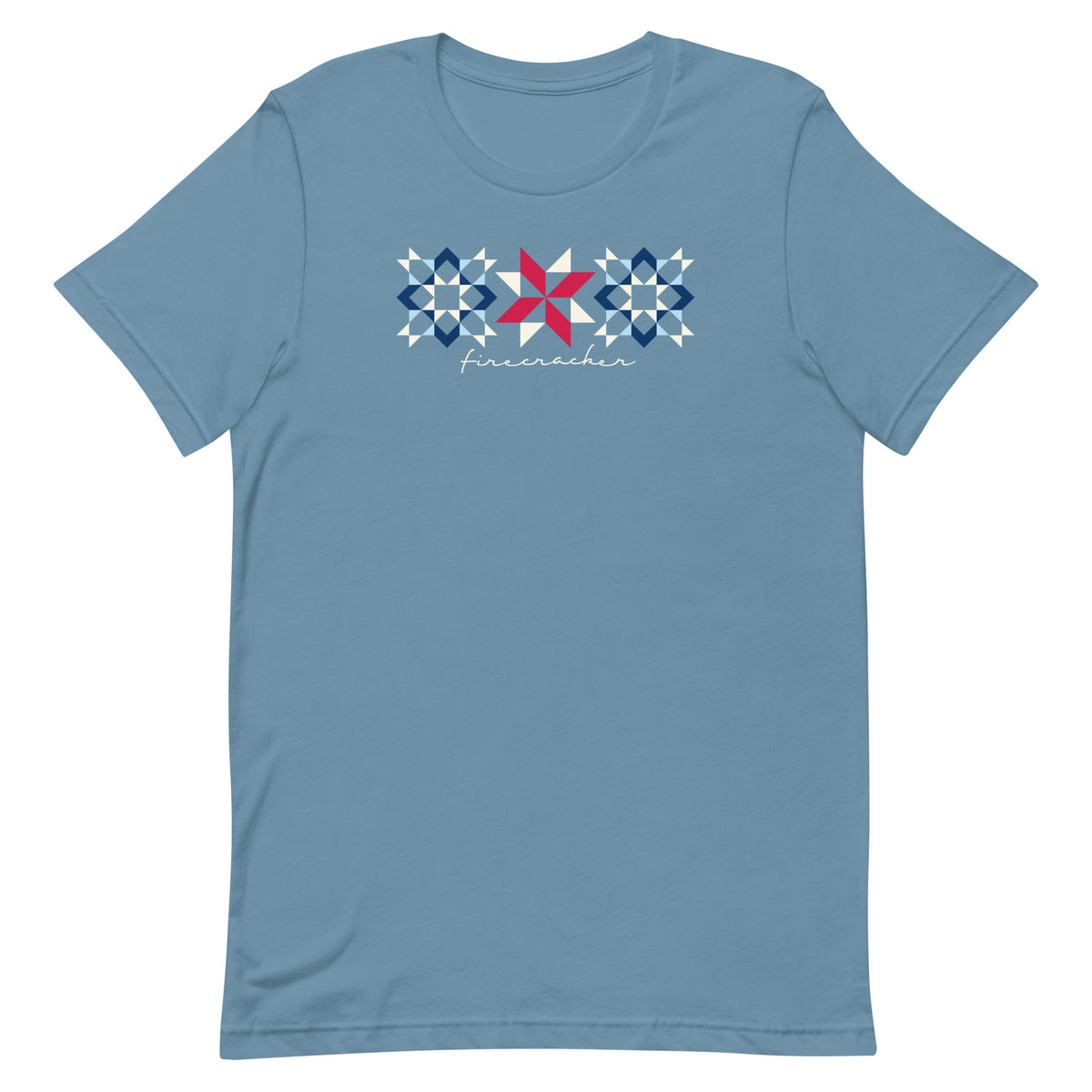Firecracker quilt-block stars with script lettering in red, white and blue on a t-shirt in steel blue, front view – Kate Spain design for Pat Sloan