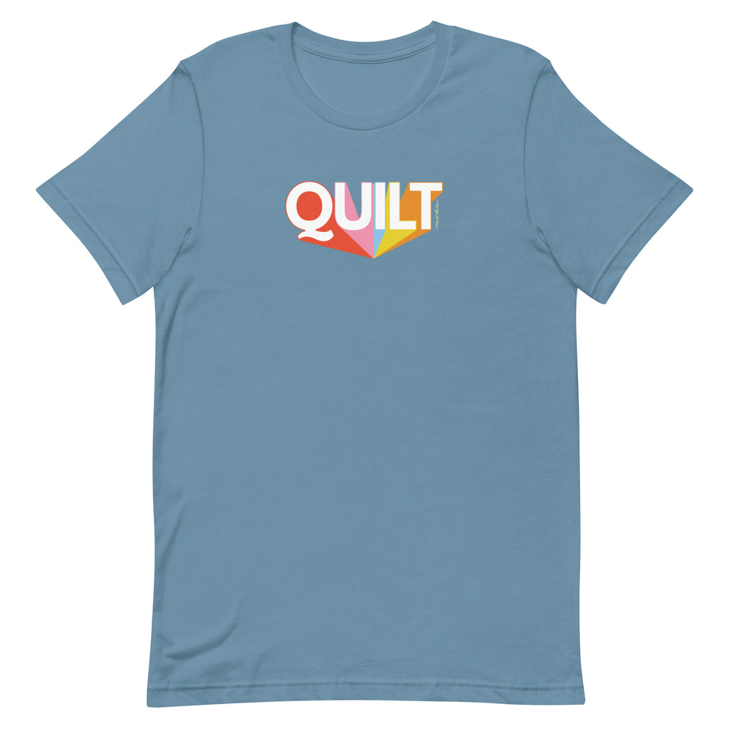 Moda QUILT logo with orange, pink, blue and yellow rays on a staple t-shirt in steel blue, front view – Kate Spain design