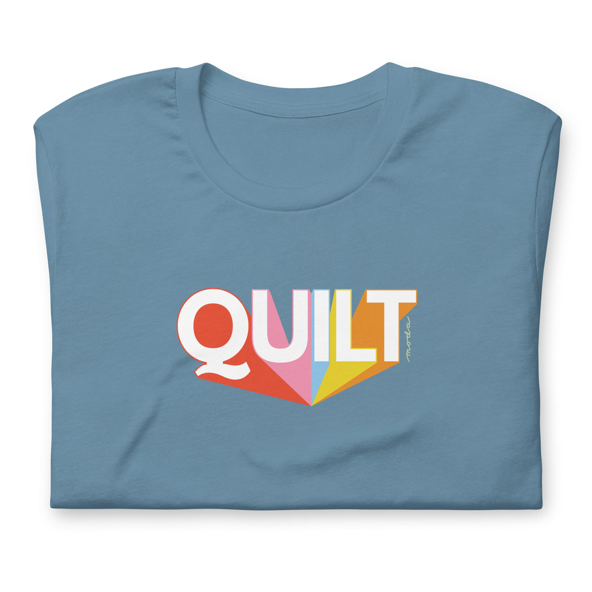 Moda QUILT logo with orange, pink, blue and yellow rays on a staple t-shirt in steel blue, folded close-up of the design – Kate Spain design