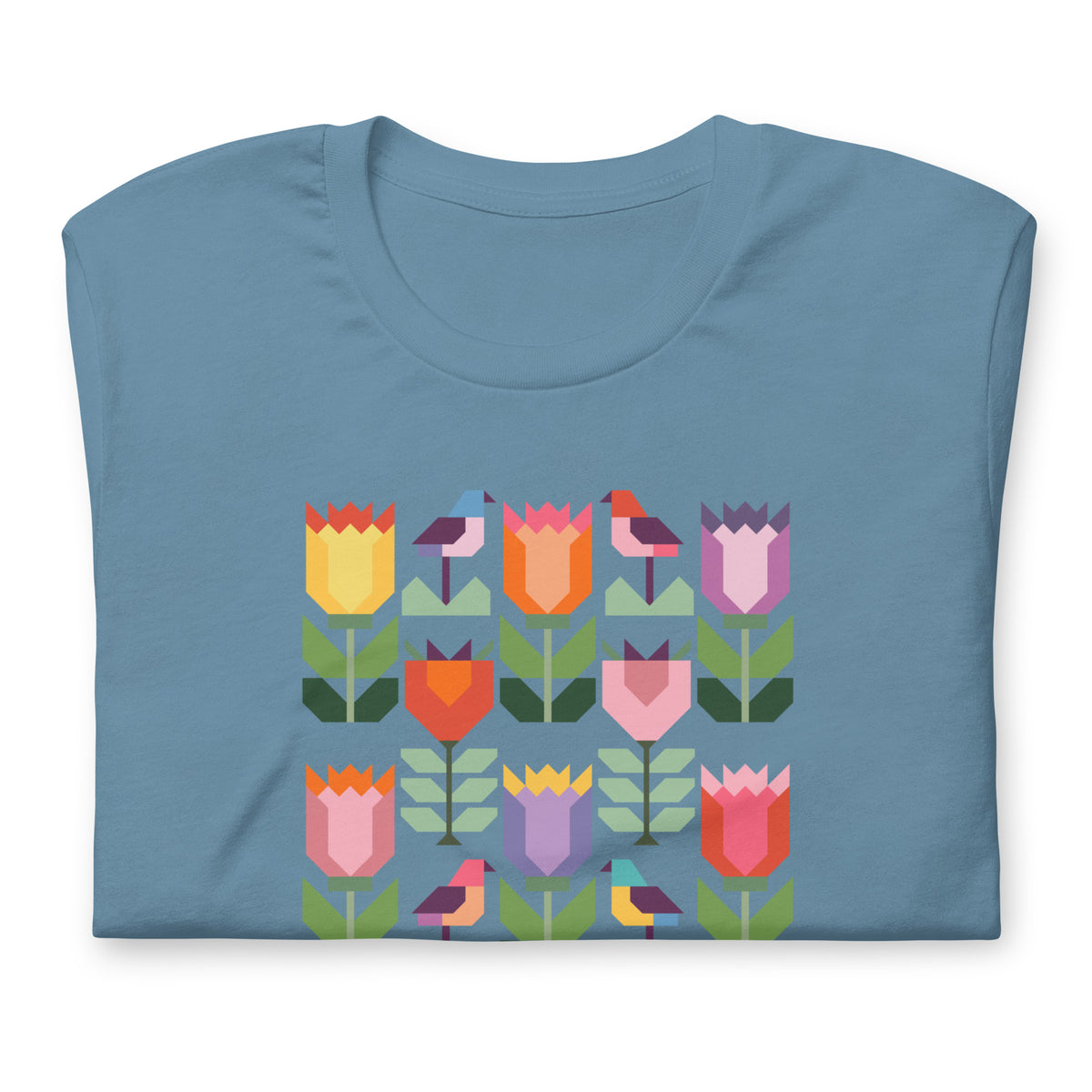 Birds + Blooms patchwork tulips and birds on a t-shirt in steel blue, folded close-up of the design – Kate Spain design for Pat Sloan