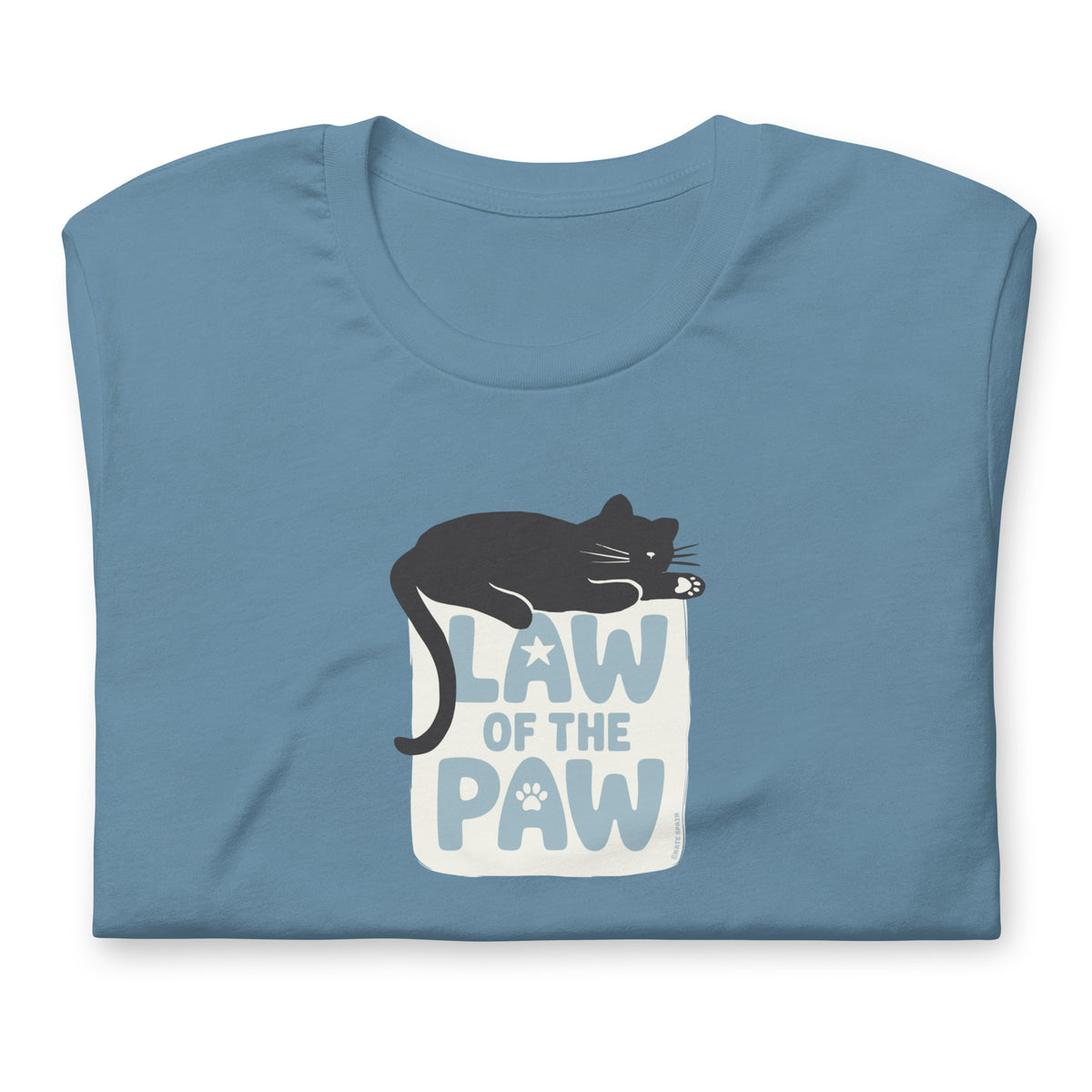 Law of the Paw® design with a cat napping on the logo on a t-shirt in steel blue, folded close-up of the design – Kate Spain design