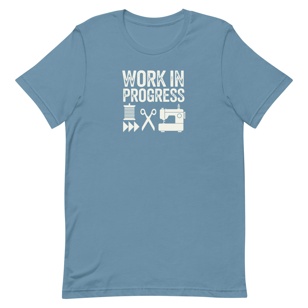 Work in Progress Mod distressed lettering with thread, scissors and sewing machine on a t-shirt in steel blue, front view – Kate Spain design for Pat Sloan