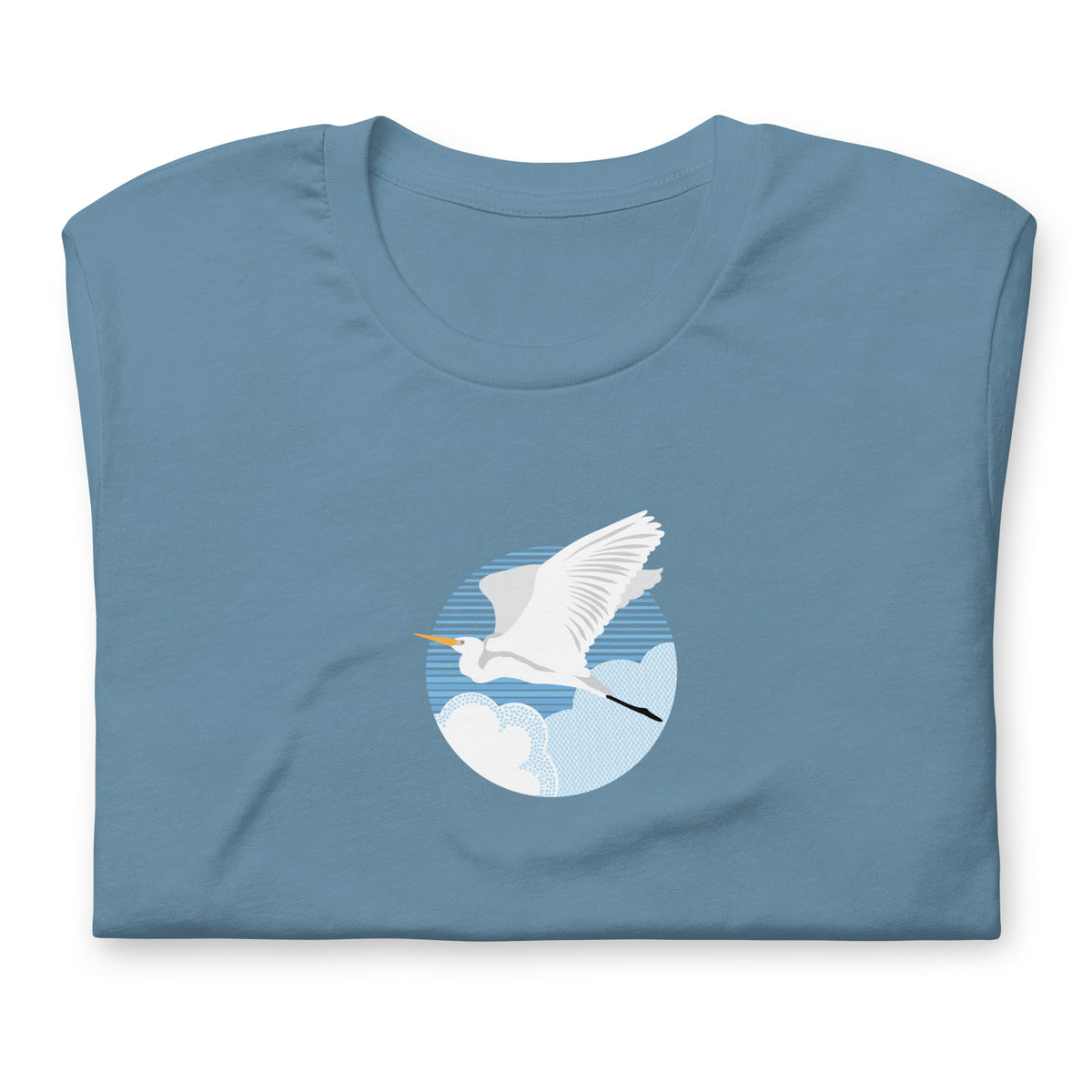 Great egret in flight against a blue circle on a t-shirt in steel blue, folded close-up of the design – Kate Spain design