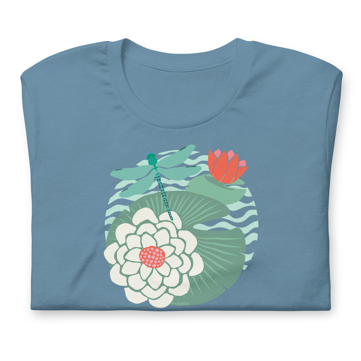 Dragonfly over water lilies and lily pads on a t-shirt in steel blue, folded close-up of the design – Kate Spain design