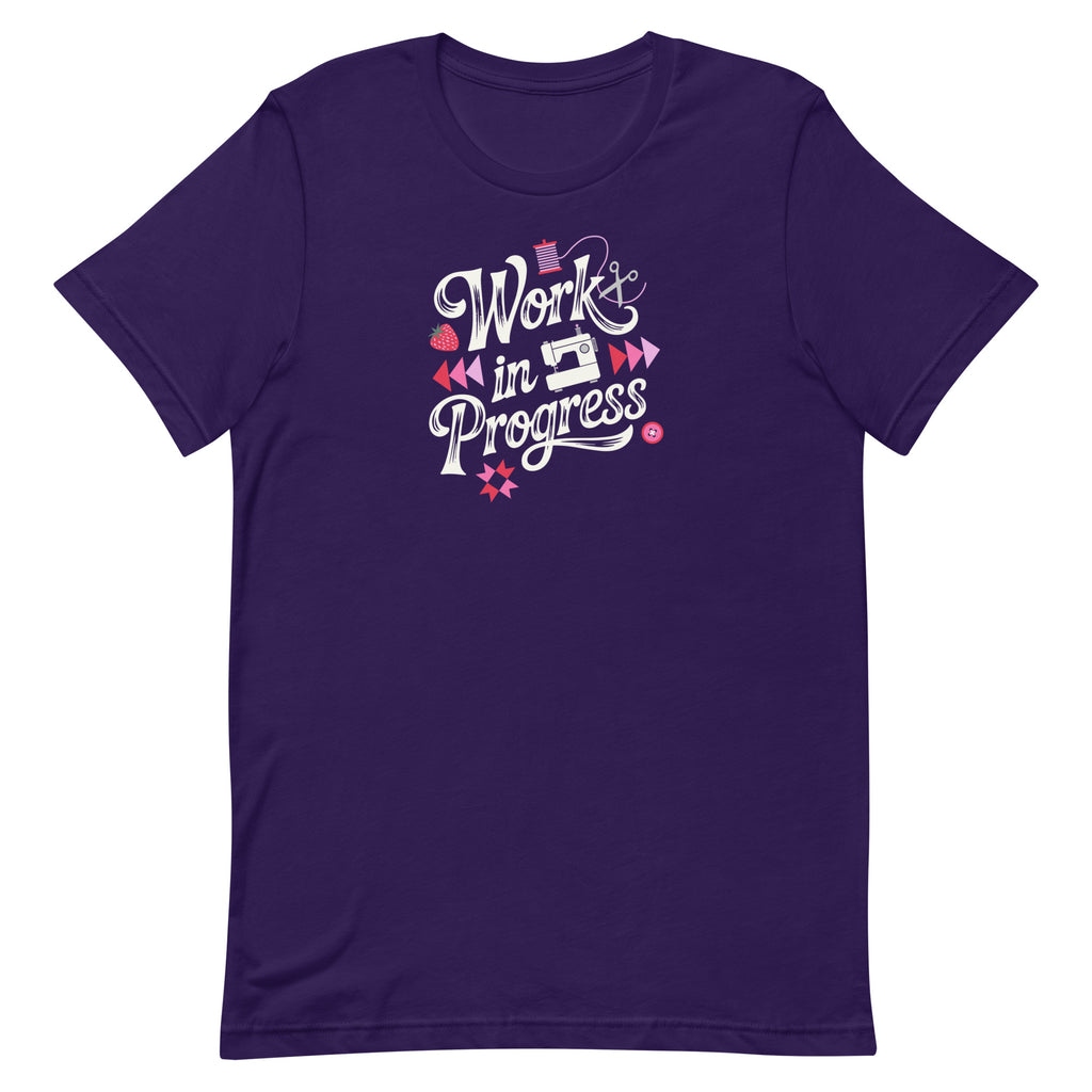 Work in Progress sewing design with flying geese, sewing machine, strawberry and thread spool on a t-shirt in purple, front view – Kate Spain design for Pat Sloan
