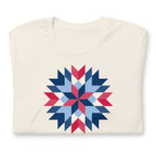 Barn Star quilt block in red, white and blue on a t-shirt in vintage white, folded close-up of the design – Kate Spain design for Pat Sloan