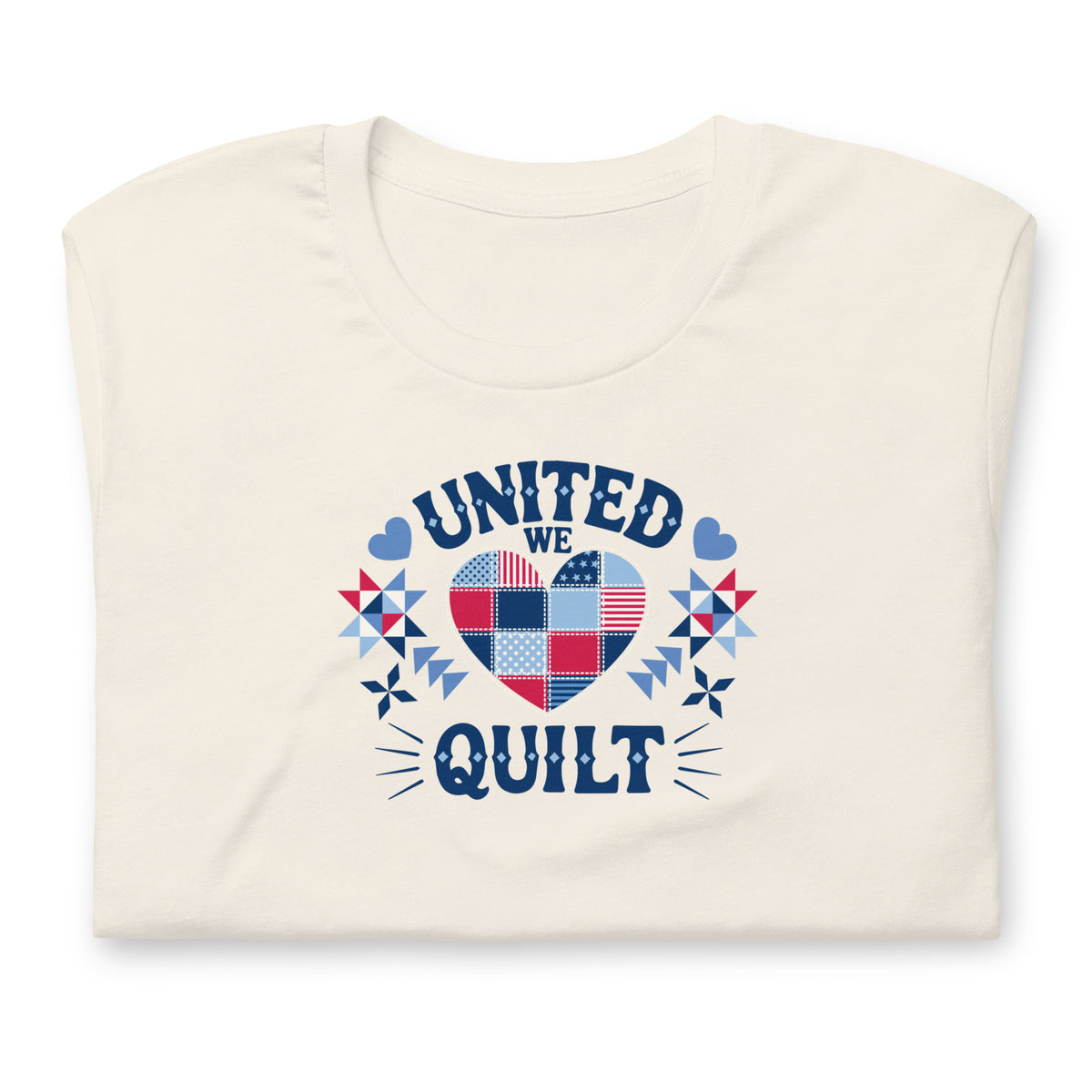 Quilters United quilt badge in red, white and blue on a t-shirt in vintage white, folded close-up of the design – Kate Spain design for Pat Sloan