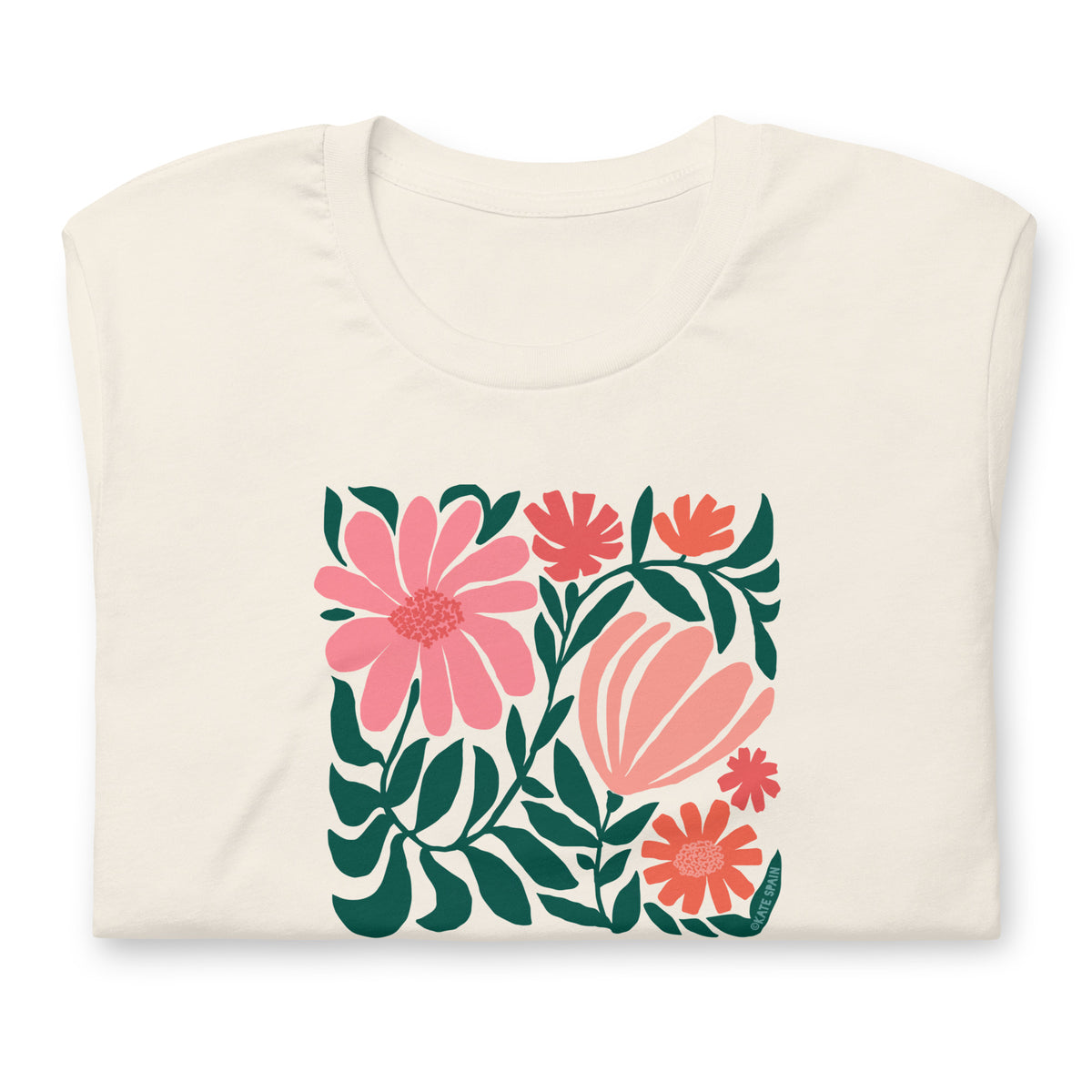 Botanica modern floral design with pink and coral blooms on a t-shirt in vintage white, folded close-up of the design – Kate Spain design