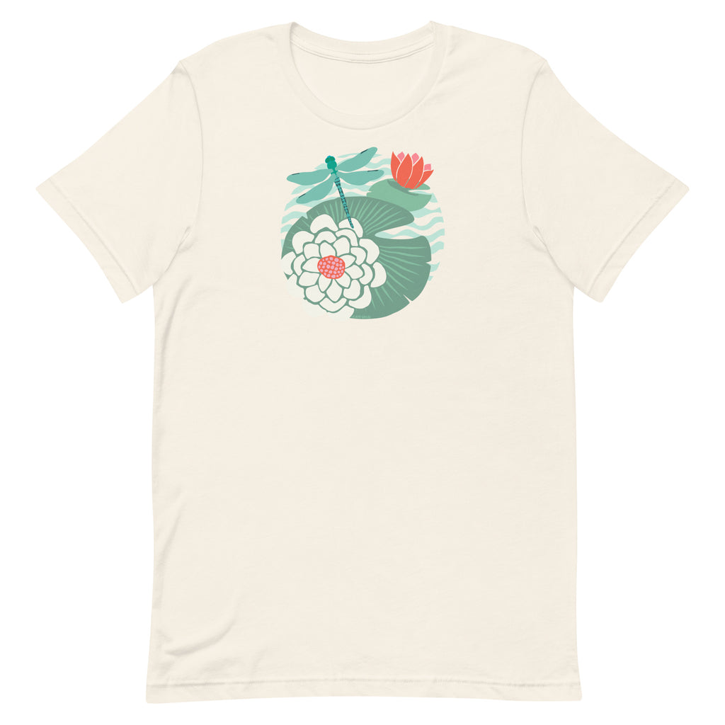 Dragonfly over water lilies and lily pads on a t-shirt in vintage white, folded close-up of the design – Kate Spain design