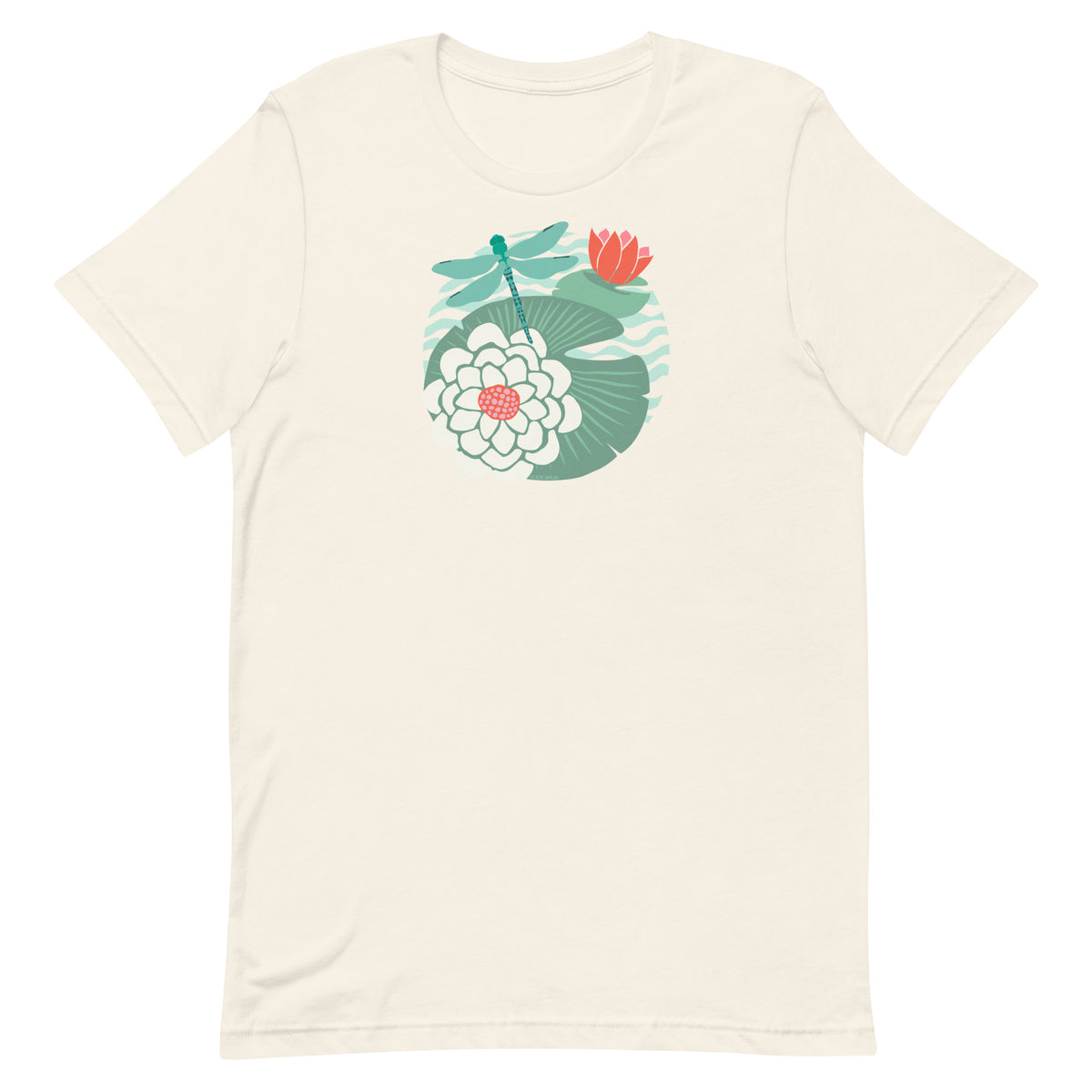 Dragonfly over water lilies and lily pads on a t-shirt in vintage white, folded close-up of the design – Kate Spain design