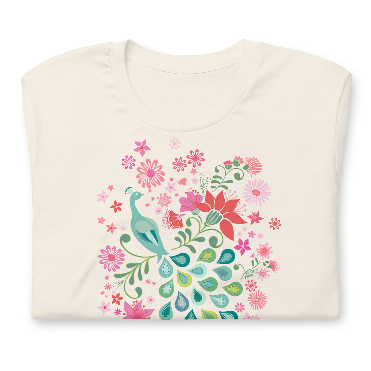 Peacock Flowers design, a peacock among coral, pink, mint and teal blooms on a t-shirt in vintage white, folded close-up of the design – Kate Spain design
