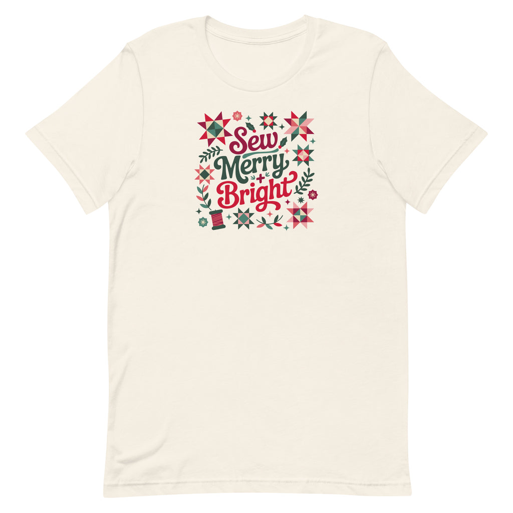 Sew Merry + Bright lettering with quilt stars and holly on a staple t-shirt in vintage white, front view – Kate Spain design for Pat Sloan