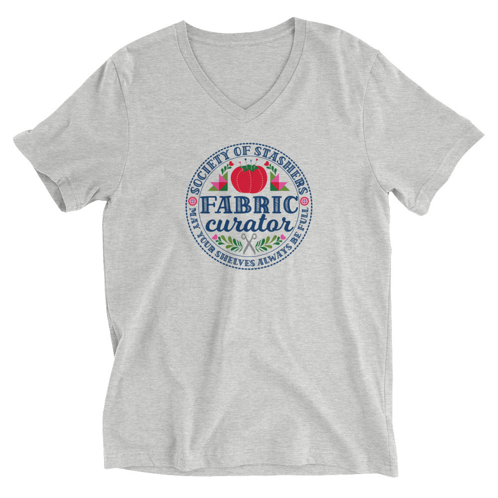 Fabric Curator Society of Stashers crest with a tomato pincushion on a unisex v-neck tee in athletic heather grey, front view – Kate Spain design for Pat Sloan