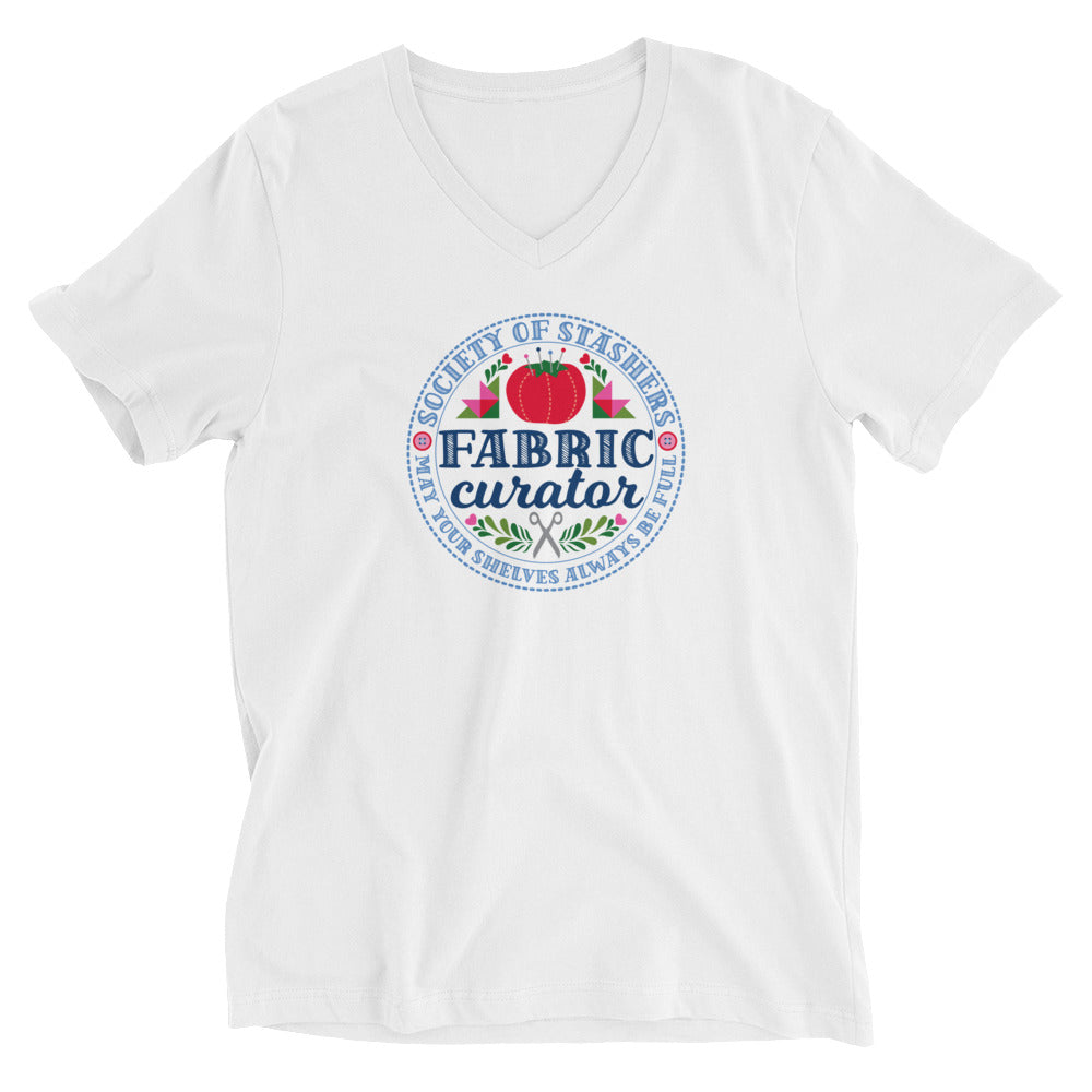 Fabric Curator Society of Stashers crest with a tomato pincushion on a unisex v-neck tee in white, front view – Kate Spain design for Pat Sloan