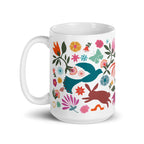 Flora + Fauna 15 oz ceramic mug with Otomi-style birds, deer, rooster, rabbit and flowers, handle on the left – Kate Spain design