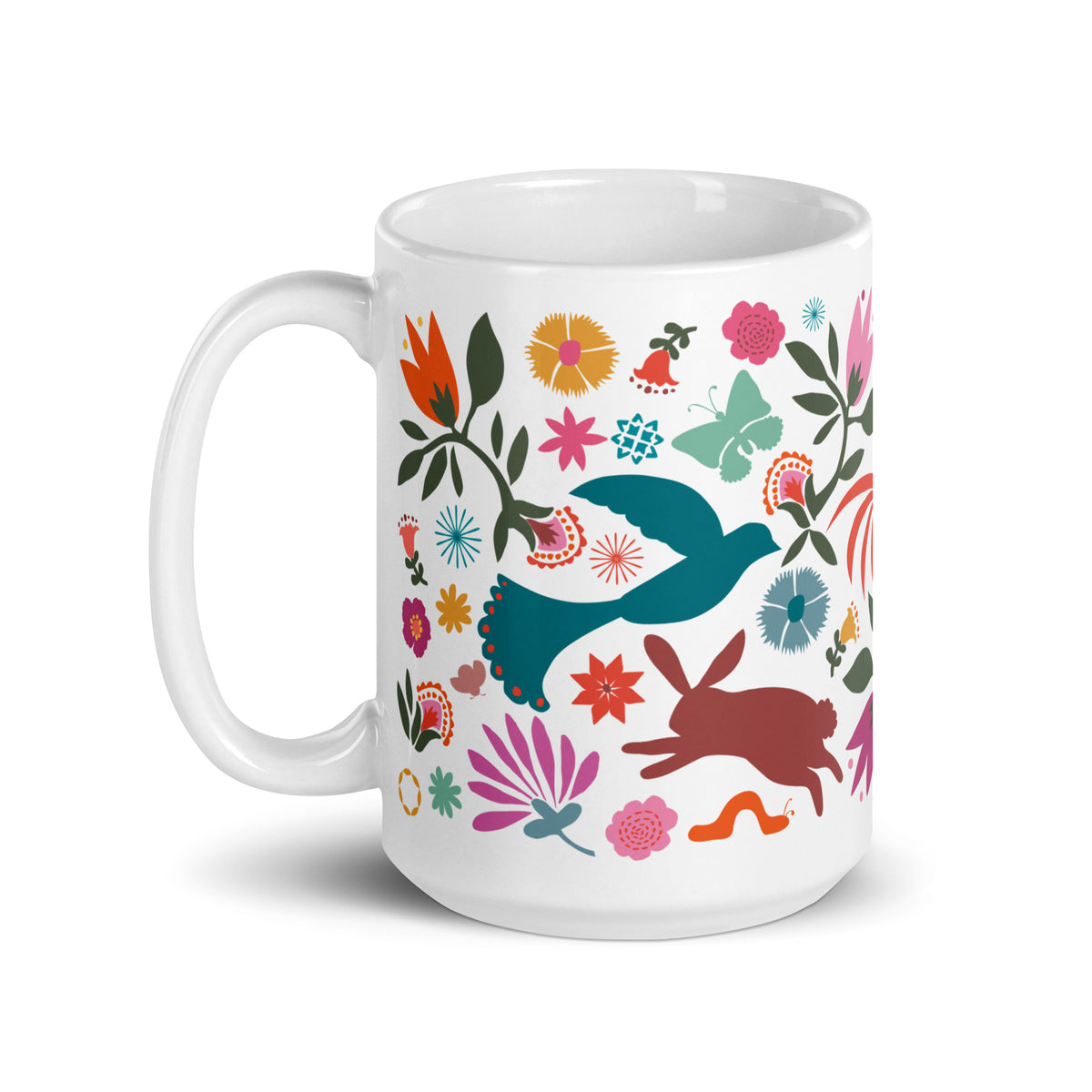 Flora + Fauna 15 oz ceramic mug with Otomi-style birds, deer, rooster, rabbit and flowers, handle on the left – Kate Spain design
