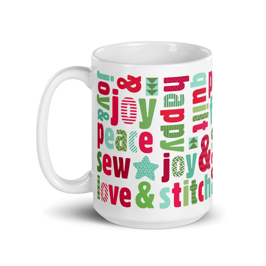 Happy Thoughts 15 oz ceramic mug wrapped in words like joy, peace, love, friends and quilt in red, green and aqua, handle on the left – Kate Spain design for Pat Sloan