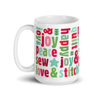 Happy Thoughts 15 oz ceramic mug wrapped in words like joy, peace, love, friends and quilt in red, green and aqua, handle on the left – Kate Spain design for Pat Sloan