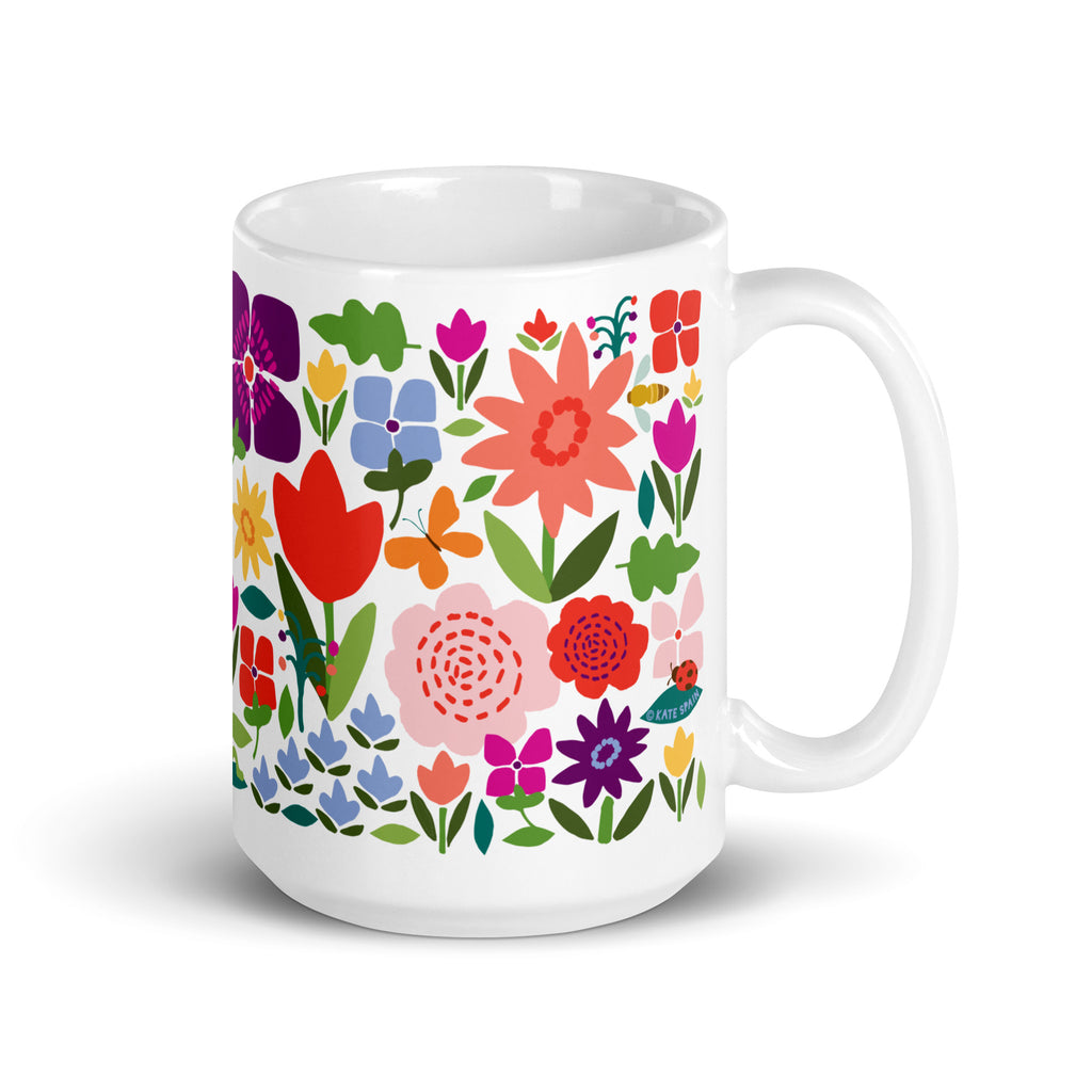 Happy Blooms 15 oz ceramic mug with bright red, purple and coral flowers, handle on the right – Kate Spain design