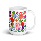 Happy Blooms 15 oz ceramic mug with bright red, purple and coral flowers, handle on the right – Kate Spain design