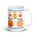 15 oz ceramic mug with the Falling for Fall patchwork pumpkin, quilt-block stars and hearts, handle on the right – Kate Spain design for Pat Sloan