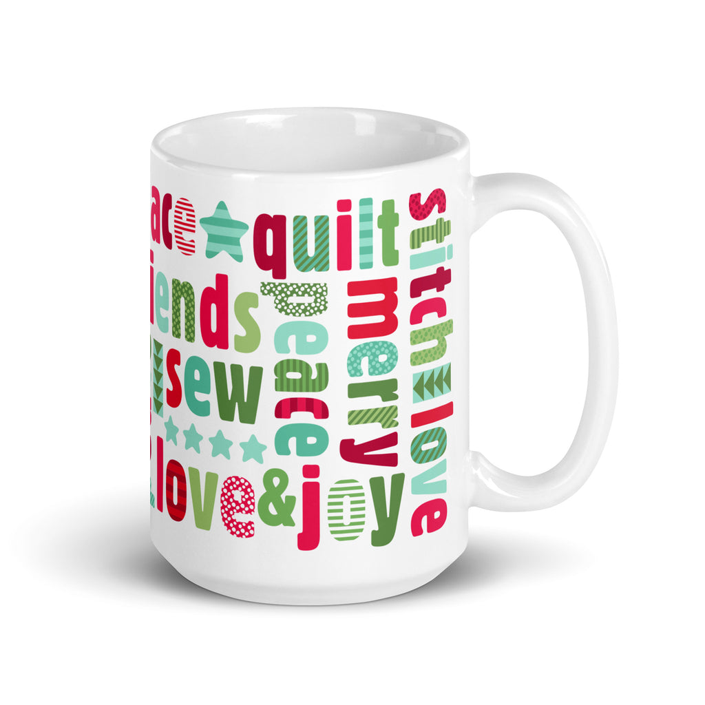 Happy Thoughts 15 oz ceramic mug wrapped in words like joy, peace, love, friends and quilt in red, green and aqua, handle on the right – Kate Spain design for Pat Sloan