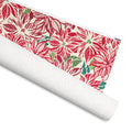 Poinsettia gift wrap, oversized red and cream poinsettias with green and teal leaves, 30 by 36 inch matte paper, shown partly rolled – Kate Spain design